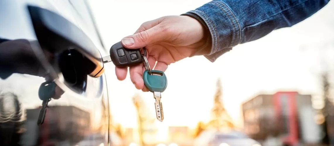 Unrecognizable woman opening her car with a key